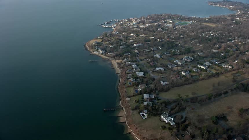 Aerial footage of luxurious waterfront homes in Great Neck NY next to Little Neck Bay during winter season