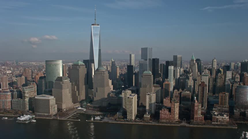 A stunning aerial view of New Yorks iconic One World Trade Center skyscraper and other high-rise buildings in downtown Manhattan on a sunny winter day