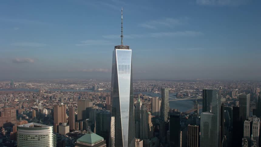 Aerial orbit of the iconic Freedom Tower in Lower Manhattan reflecting the suns rays during a hazy winter day in New York City
