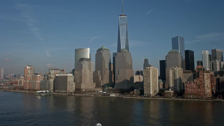 A breathtaking aerial view of One World Trade Center and the iconic skyline of Lower Manhattan New York City on a sunny winter day