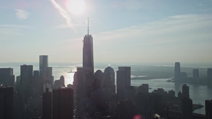 A breathtaking aerial view of One World Trade Center towering over Lower Manhattans high rises and skyscrapers during winter in New York City