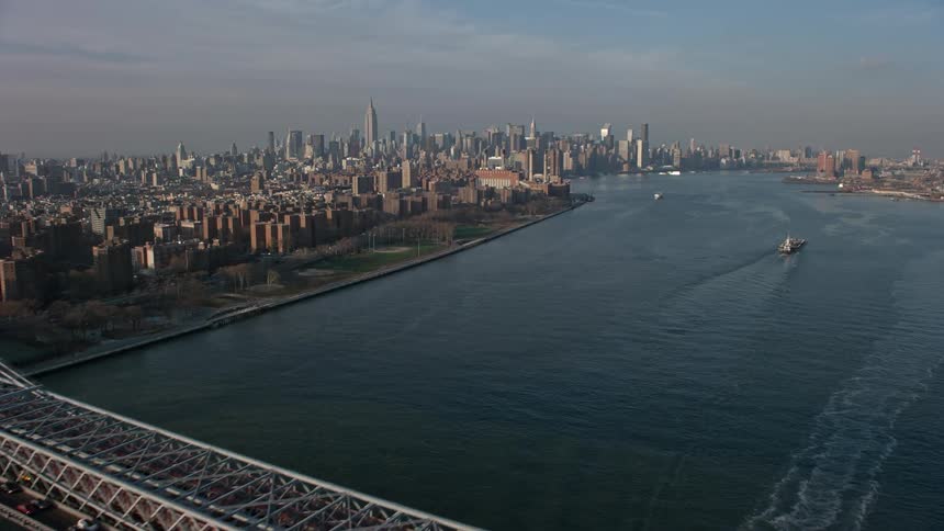 Aerial view of Williamsburg Bridge crossing the East River as it approaches Midtown Manhattan skyline in the winter New York City