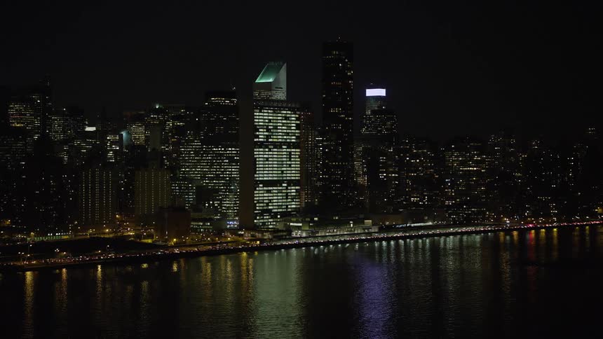 Aerial footage of the iconic United Nations building in Midtown Manhattan New York City during a clear winter night