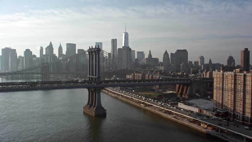 Aerial view of Manhattan and Brooklyn bridges along with the Lower Manhattan skyline during winter in New York City