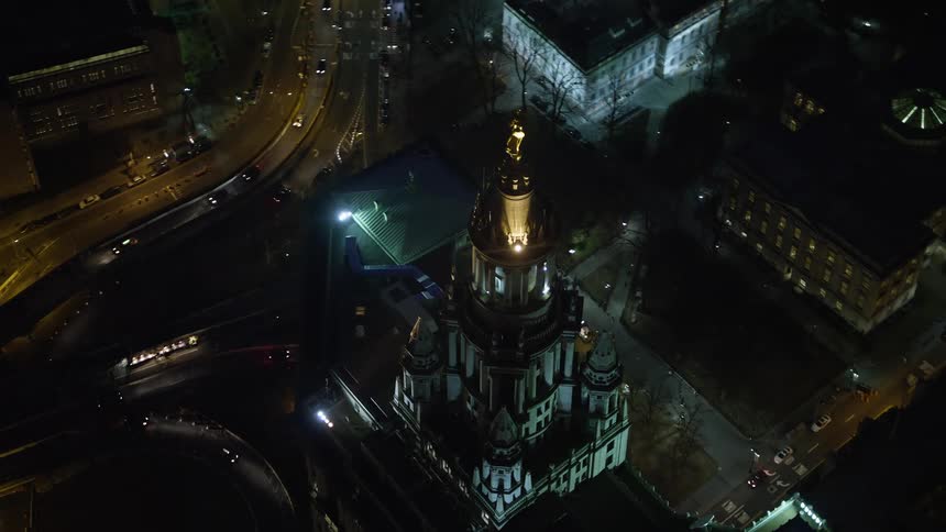 Aerial footage orbits the top of the Manhattan Municipal Building at night showcasing the historic landmark and downtown Manhattan area during winter without snow