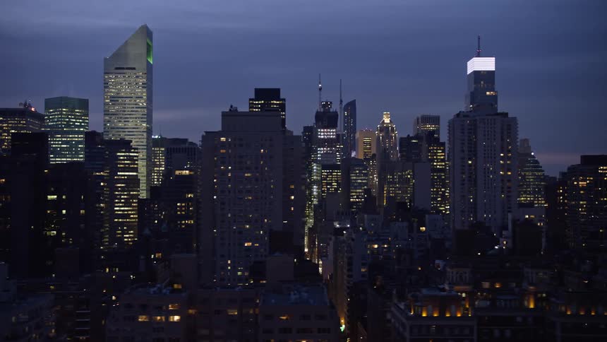 Aerial view of busy winter night streets between skyscrapers in Midtown Manhattan New York City