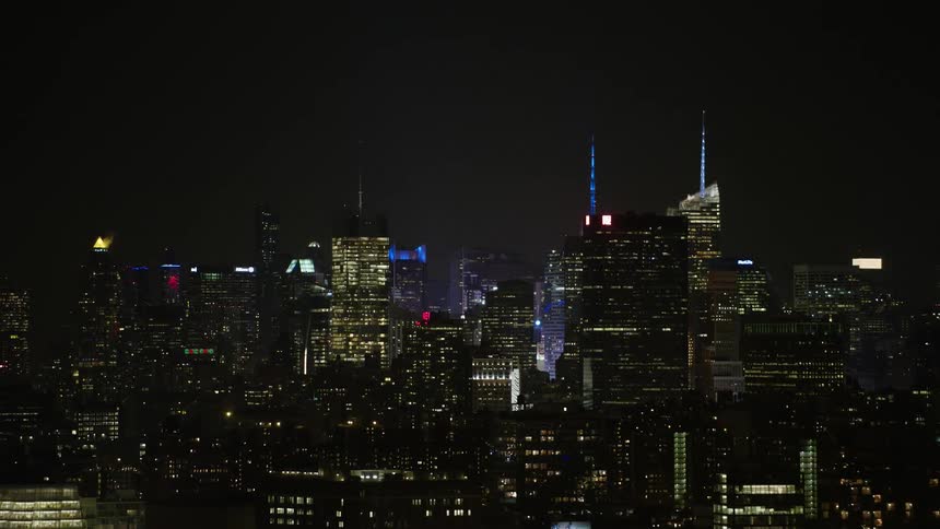 An aerial shot of the glittering high rise buildings of Midtown Manhattan in New York City during winter at night