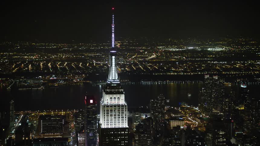 A breathtaking aerial view of Empire State Building and the illuminated buildings of New York City during winter nighttime