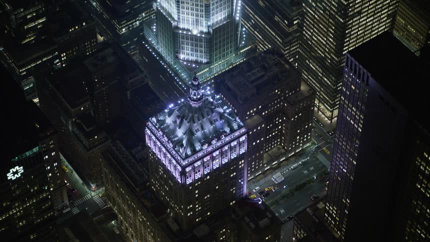 Aerial footage orbits the Helmsley Building in Midtown Manhattan on a winter night with clear skies showcasing the industrial and office buildings of the Big Apple