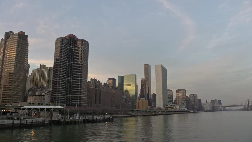 A breathtaking aerial view captures the United Nations and the Manhattan waterfront condominiums at sunset