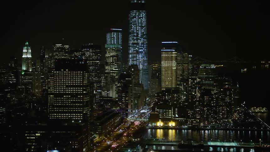 Approaching West Street and piers in Greenwich Village with the stunning skyscrapers of Lower Manhattan visible in the background during a clear winter night