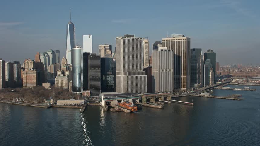 A stunning aerial flyby of Battery Park the Lower Manhattan skyline and the Staten Island Ferry Terminal showcasing the metropolis of New York City during winter