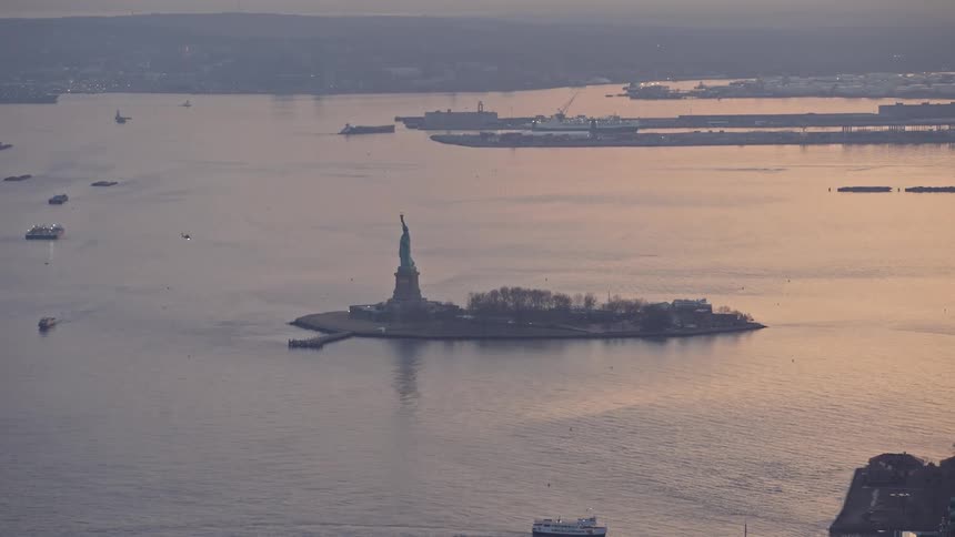 Aerial footage of the Statue of Liberty and Liberty Island at winter twilight in New York