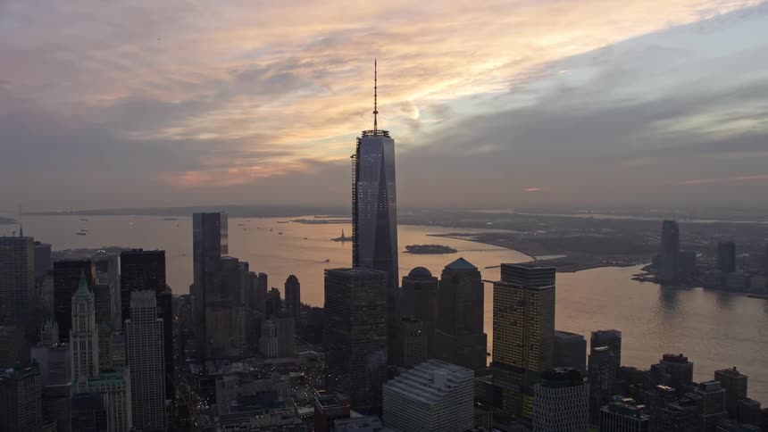An aerial view during sunset showcases One World Trade Center and other iconic skyscrapers in Lower Manhattan during winter