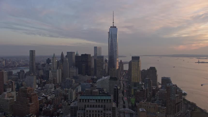 A stunning aerial view of One World Trade Center dominating over the Lower Manhattan skyscrapers during sunset in winter