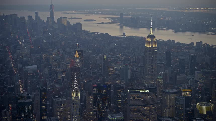 Aerial view of the Empire State Building and other tall buildings illuminated at twilight during winter in Midtown Manhattan New York City