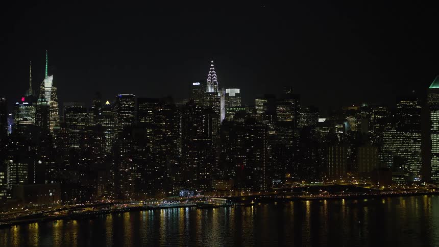 Approaching the iconic Chrysler Building and Midtown Manhattan skyscrapers we get a stunning night view of the metropolis one of the most famous cities in the world