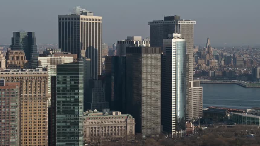 Aerial view of high rise buildings in Lower Manhattan during winter revealing Brooklyn skyscrapers across the river