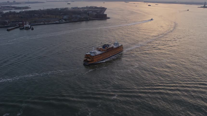 A Staten Island Ferry sails through New York Harbor during twilight winter hours