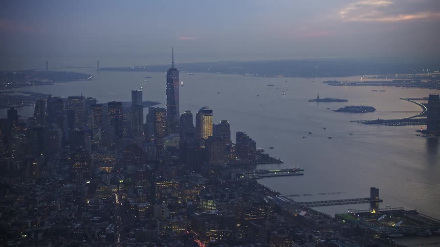 A mesmerizing aerial view of Lower Manhattans skyline including the iconic Freedom Tower and New York Harbor during winter twilight