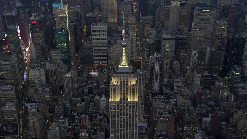 Approaching the iconic Empire State Building in Midtown Manhattan during the winter twilight