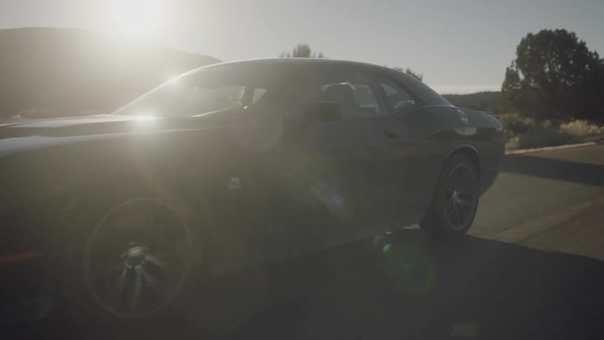 A car drives on a road in the desert