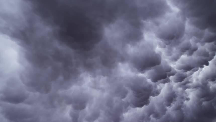 Clouds float and move across the sky seeming to spread out and open a vortex before moving over it