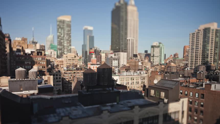 A shadow is seen moving over buildings in a downtown area