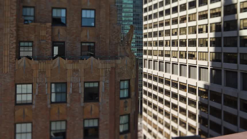Time lapse of the shadows of skyscrapers passing over the facade of buildings in the city