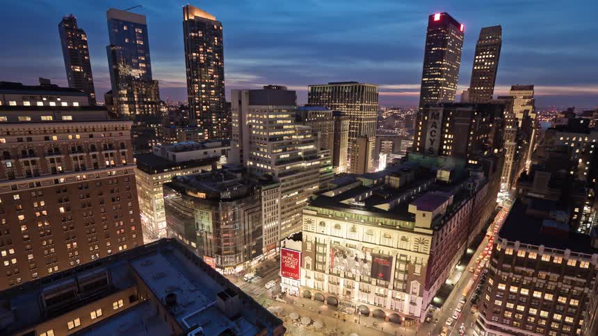 Heavy traffic flows along downtown streets asnight falls