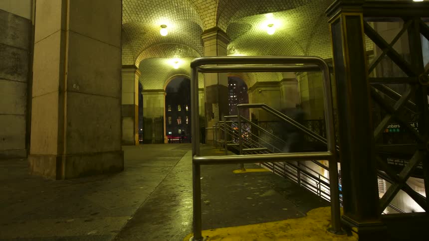 People walk in and out of a train depot