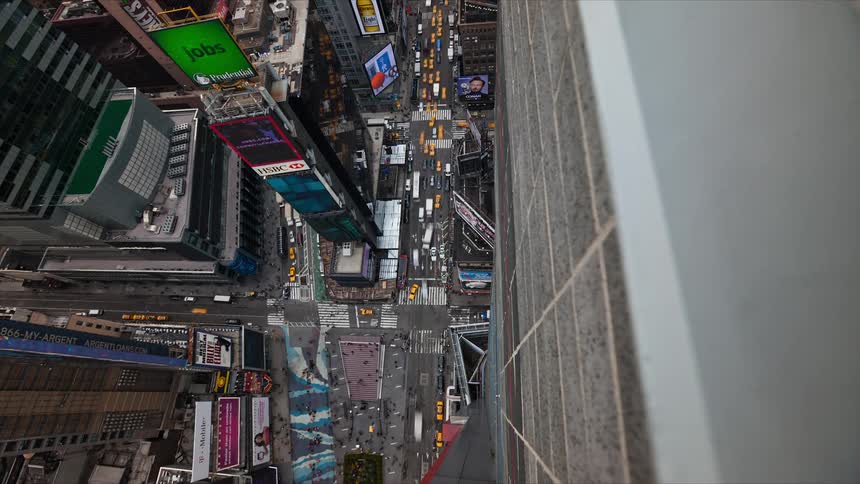 A busy downtown intersection teems with pedestrians and vehicles in this time lapse