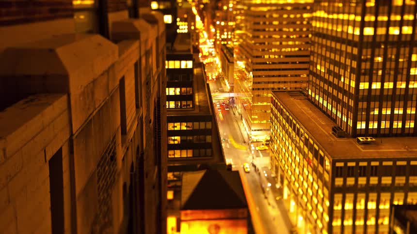 Time lapse of cars driving on a busy avenue in the city downtown from day to night