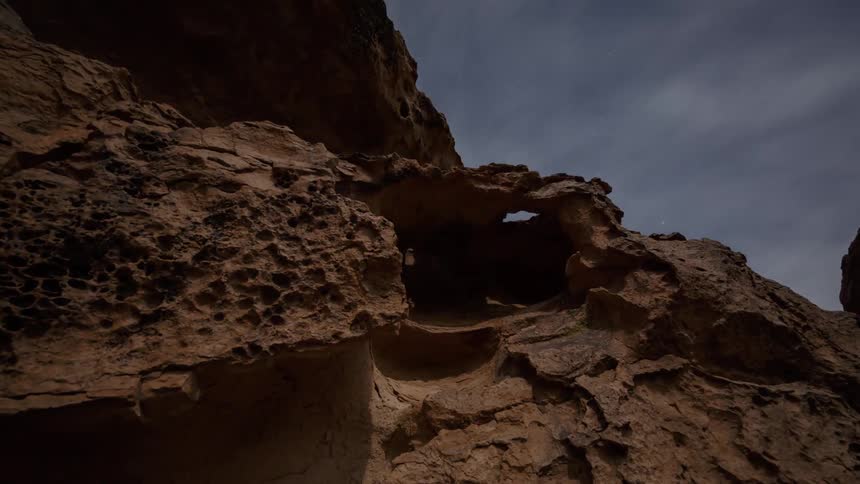 A rocky mountain is seen from below