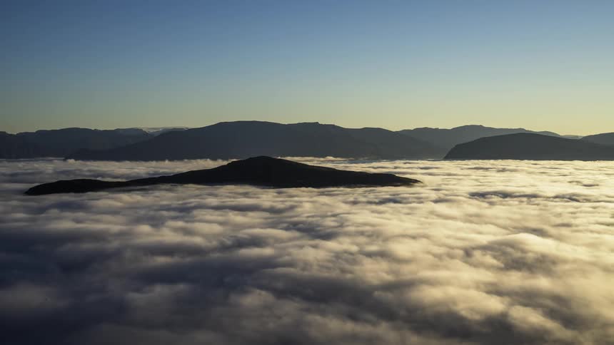 A time lapse of clouds over hills