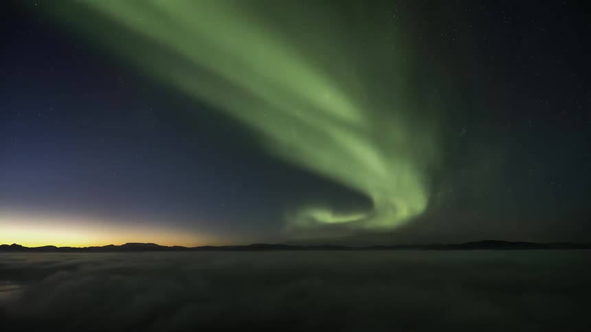 The beauty of the northern lights in the nighttime sky is seen in a time lapse