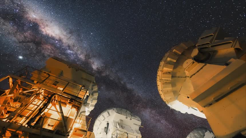 A view of stars outdoors with telescopes pointed at it