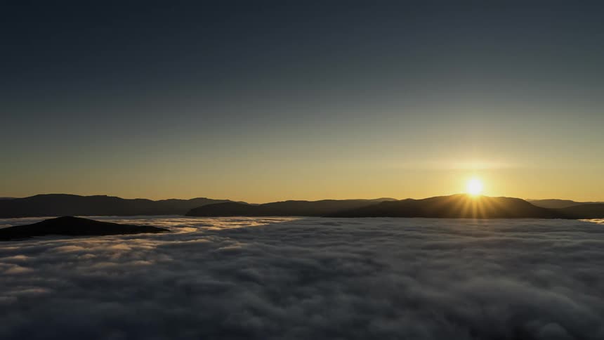 Time lapse view of the sun setting above the ocean water