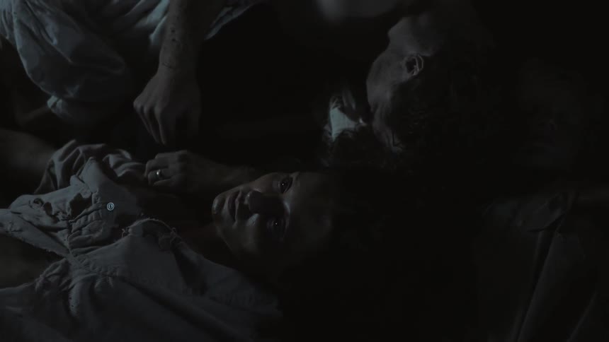 People are laying down in a dark area
