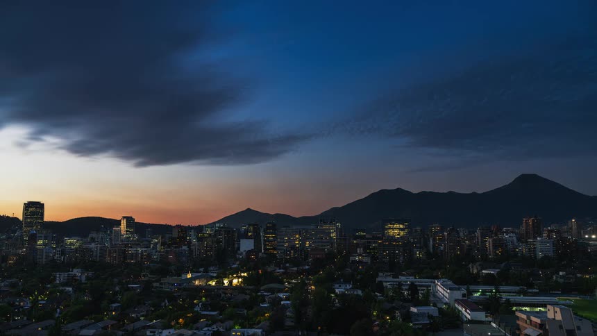 Time lapse view of the sun setting above the urban city