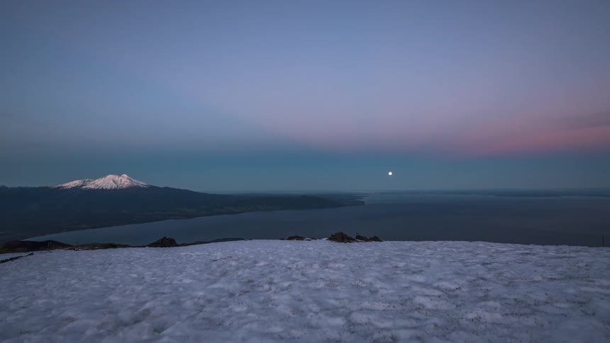 Arctic sun sets over the ocean turning the horizon red