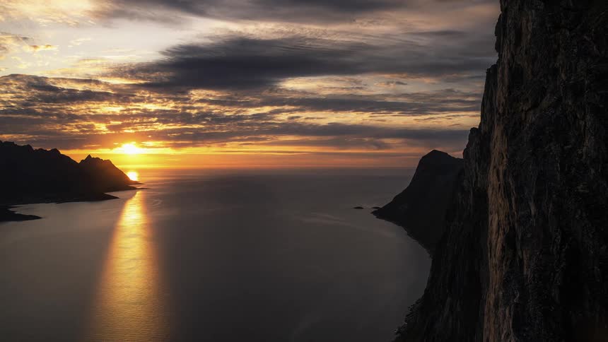 Aerial view of sunrise from bay near a cliff ridge