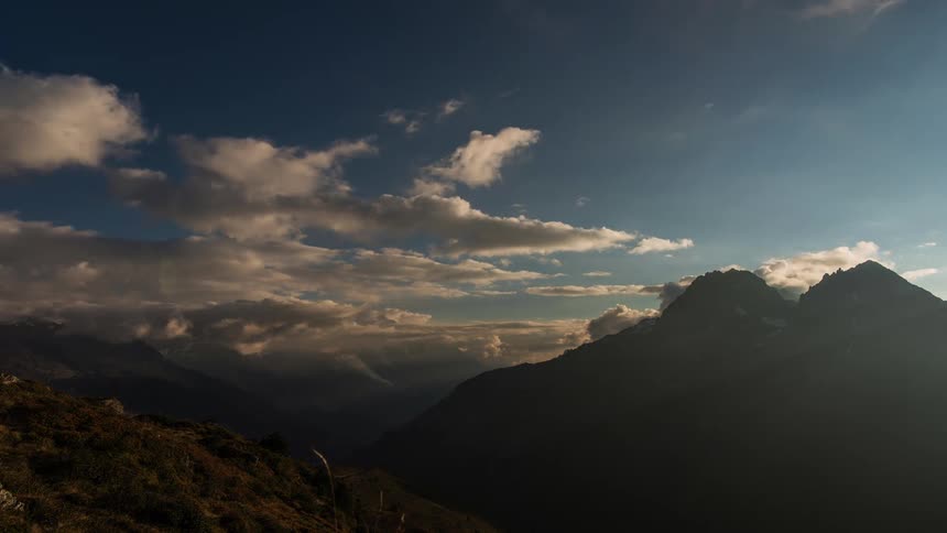 Landscape of mountain slopes and valley at dusk