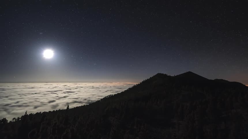 A time lapse shows the sun falling below the horizon and the night sky becoming visible