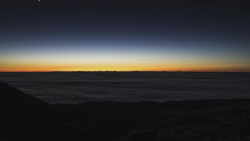 Time lapse of full moon and venus setting on the horizon at evening
