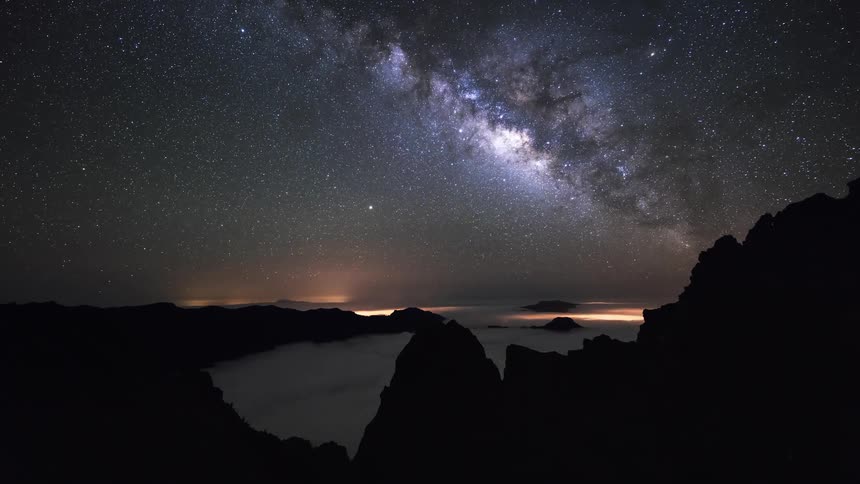 A time lapse shows a phenomenally beautiful starry night above a mountain range