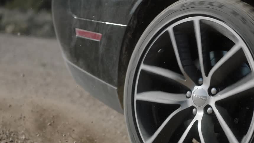 A car spins out as it drives in the dirt