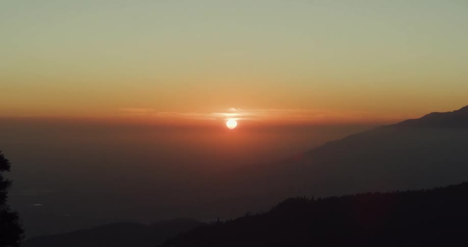 The sun sets over a vast canyon