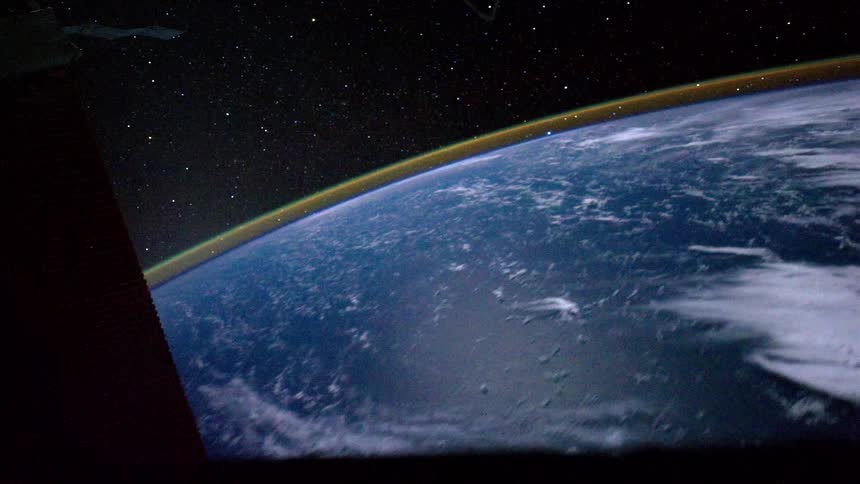 A view of the earth through the window of a moving space ship