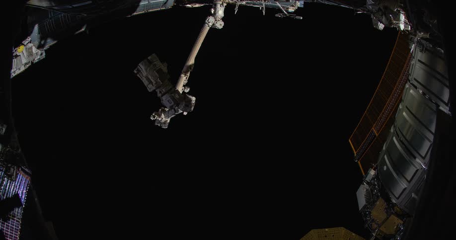 A satellite flies over the earth as it turns in space